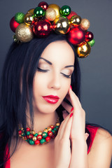 beautiful woman wearing a wreath made from Christmas decorations