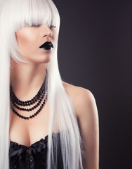 beautiful blonde woman with black make-up and accessories