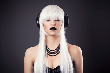 beautiful blonde woman with black make-up and accessories listen