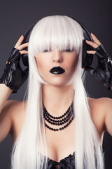 beautiful blonde woman with black make-up and accessories listen