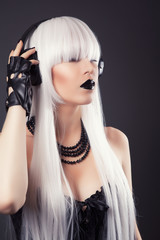 beautiful blonde woman with black make-up and accessories listen