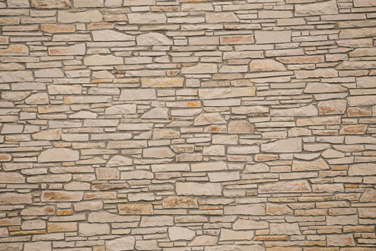 A dry stone wall made of random grey stone. wall of stones 