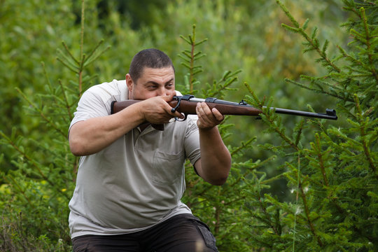 the hunter shooting from a rifle