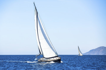 Sail yachts in regatta in open the Sea. Luxury yachts.