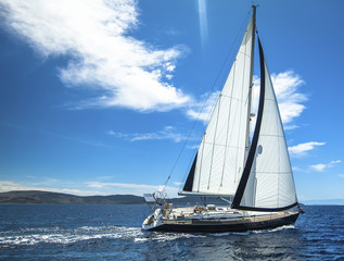 Fototapeta na wymiar Sailing in the wind through the waves. Sailing. Luxury yachts.