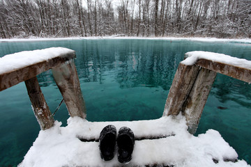 Winter swimming in blue lake - obrazy, fototapety, plakaty