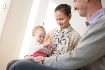 Three generations. Grandfather, young mother and baby
