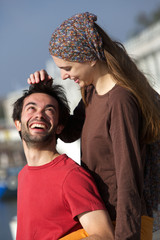 Happy young playful couple smiling together outdoors