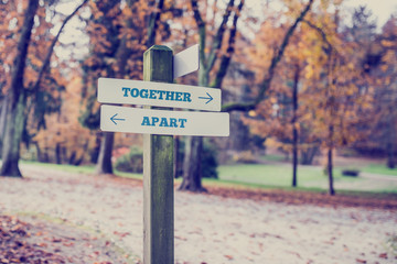 Rustic wooden sign with the words Together- Apart