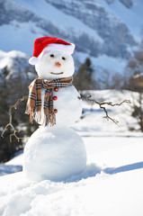 Snowman against Alpine panorama