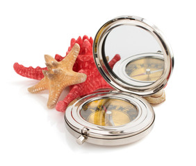 compass and seashell on white