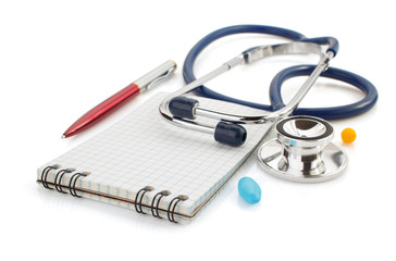 stethoscope and notebook on white