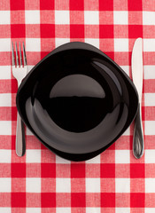 knife and fork at plate on napkin