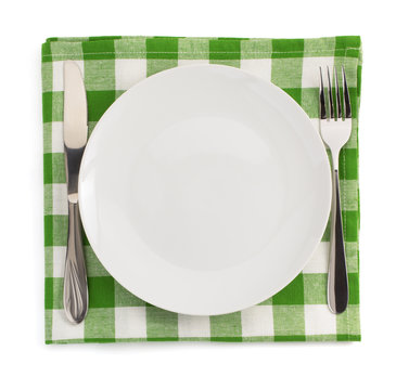 knife and fork at plate on white