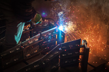 Multicolored sparks during MIG welding - obrazy, fototapety, plakaty