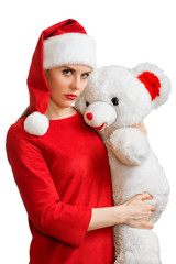 Woman in red santa hat holding white toy bear