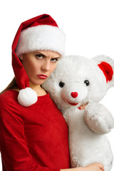 Woman in red santa hat holding white toy bear