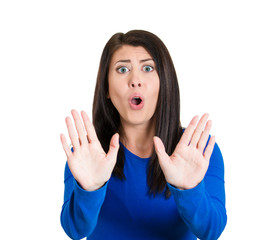 Fototapeta premium Cautious afraid annoyed displeased woman raising hands stop