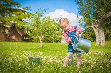 Little gardiner on the green grass in a summer day