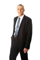 Smiling businessman with hand in pocket