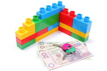 Wall of colorful building blocks with home keys and money