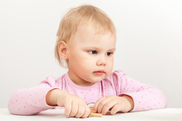 Cucasian baby girl in pink on white background