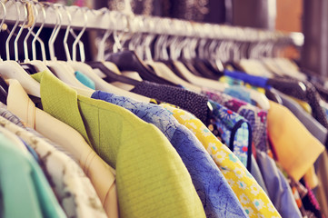 clothes hanging on a rack in a flea market