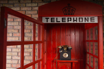 Obraz premium Red Public Telephone Booth with Open Door