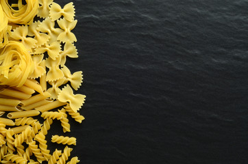 Differnent types of pasta on a dark background