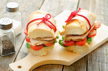 sandwich with meat, spinach and tomato