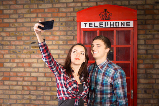 Couple Taking Self Portrait with Red Phone Booth