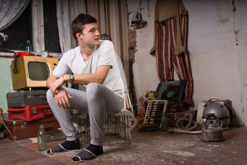 Sitting Man at Junk Room Looking at Right Frame