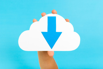 Hand showing downloading content arrow symbol on cloud.