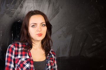 Female in Checkered Shirt in Front Chalkboard
