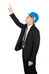 Side view of businessman engineer pointing up