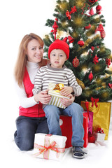 Fototapeta na wymiar Mother and son with gifts under Christmas tree