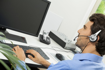 Man wearing headset giving online chat and support