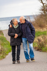 happy mature couple relaxing baltic sea dunes