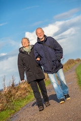 happy mature couple relaxing baltic sea dunes