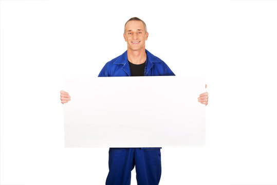 Happy worker presenting empty banner