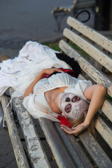 The girl in the image of Santa Muerte lies on a bench