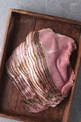 fresh sliced beef pastrami in wooden tray