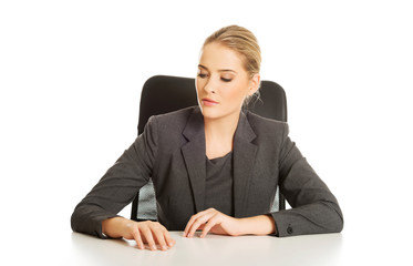 Smiling businesswoman sitting at the desk