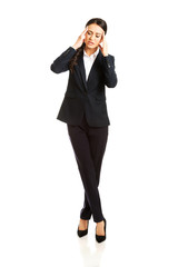 Full length businesswoman having huge headache