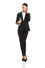 Full length businesswoman holding her notes