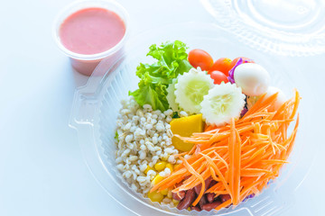 Fresh vegetable salad mix packed in the plastic box with  strawb