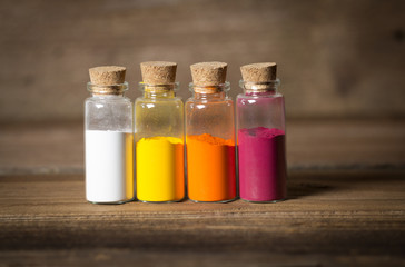 Glass bottles filled with coloured powder