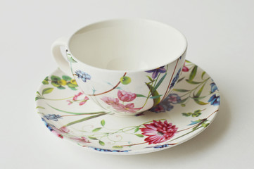 Flowery teacup and saucer of porcelain