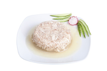 Jellied meat with vegetables on a white dish