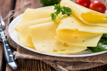 Sliced Cheese on wooden background